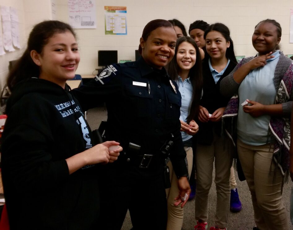 Students in Right Moves For Youth enjoy small group mentoring with one of their mentors, a school resource officer with Charlotte Mecklenburg Police Department